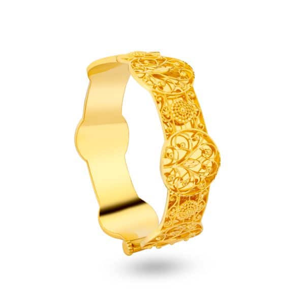 Overview An ode to timeless craftsmanship, this 21K gold bangle features intricate filigree detailing that celebrates classic Middle Eastern artistry. The openwork floral patterns reflect the beauty of tradition, reimagined for today’s woman. Design details • Crafted in rich 21K yellow gold. • Intricate handcrafted filigree design with ornate motifs. • Bold, sculptural silhouette with smooth inner finish for comfort. • High-polish surface accentuates every detail and curve. Style notes A statement of heritage and grace. Perfect for weddings, festive occasions, or as a standout everyday piece for those who treasure timeless beauty. At a glance Metal: 21K yellow gold Finish: High polish with filigree detailing Design: Traditional openwork floral motif Style: Classic heritage bangle
